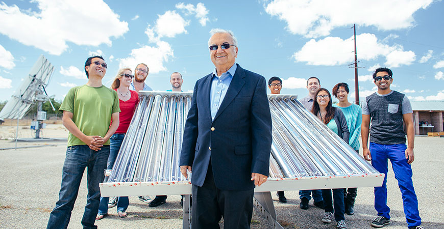 Professor Winston with his research team and a solar collector.